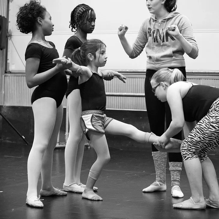 instructor working with a class on practicing a lift